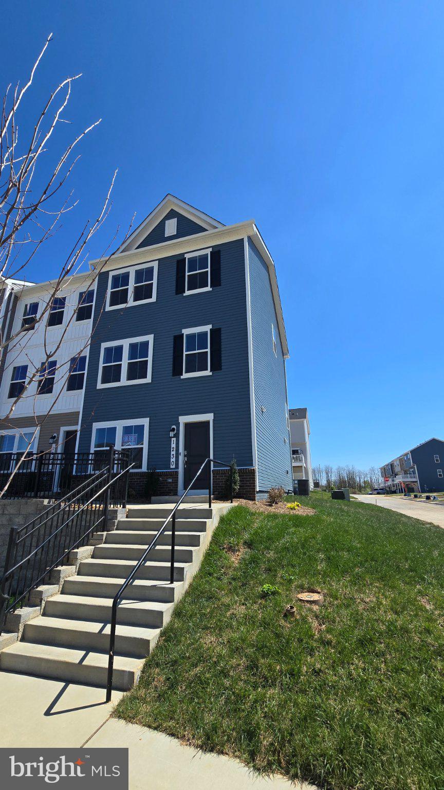 Charming blue home under clear skies.