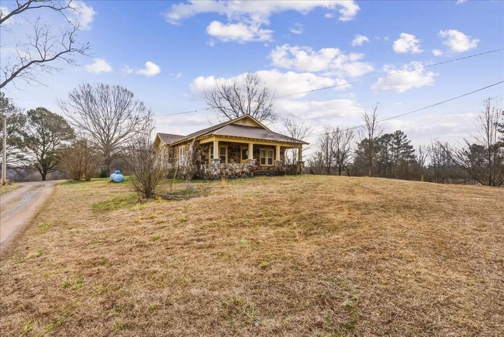 2721 Sugar Valley Road Northwest Sugar Valley, GA 30746 - Photo 8 of 24 a view of a yard with a house in the background