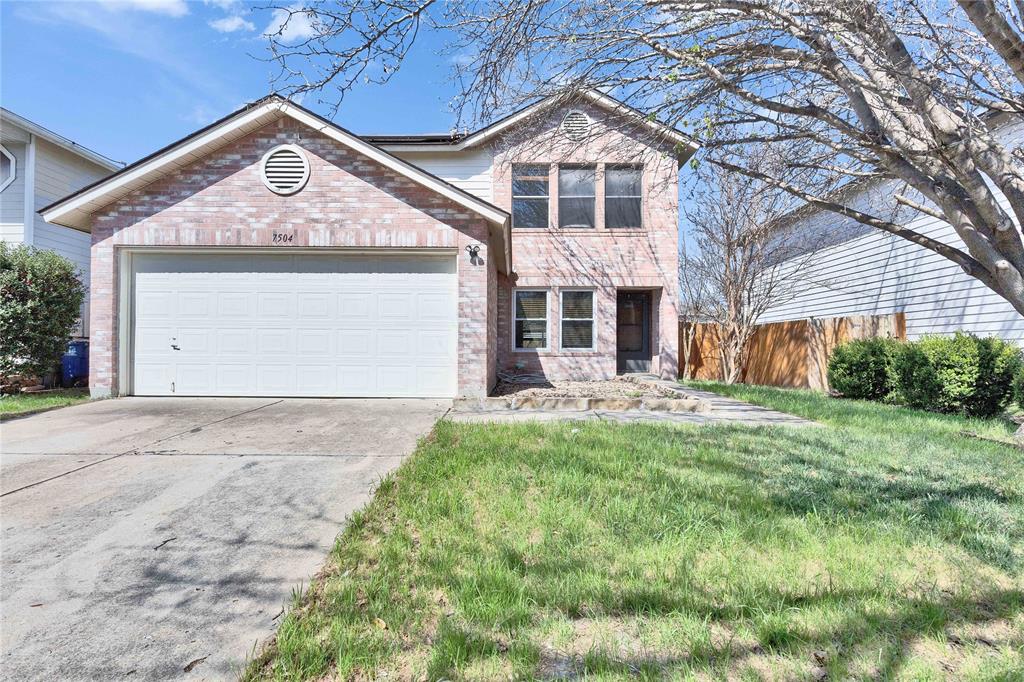 7504 Redrick Drive Austin, TX 78747 - Photo 2 of 34 The property features a two-story exterior with brick detailing, a front lawn, and a two-car garage