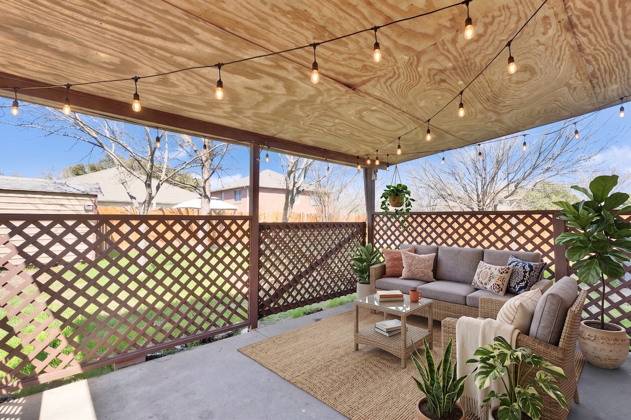 7504 Redrick Drive Austin, TX 78747 - Photo 27 of 34 The covered patio features string lighting, a lattice privacy screen, and a concrete floor