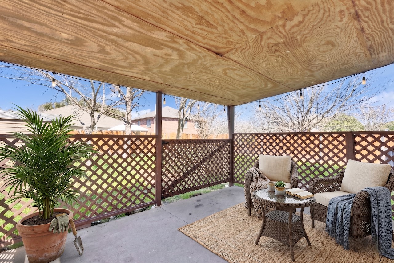 7504 Redrick Drive Austin, TX 78747 - Photo 28 of 34 The property features a covered patio with a plywood ceiling and string lights
