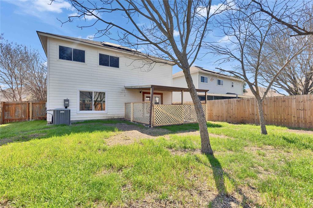 7504 Redrick Drive Austin, TX 78747 - Photo 31 of 34 The property features a private yard with a wooden fence and a covered patio area