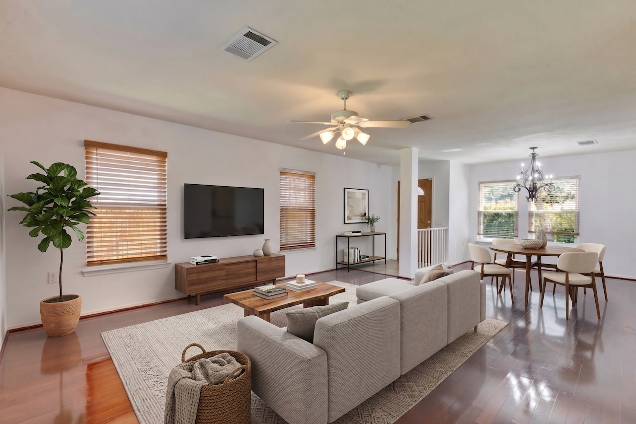 7504 Redrick Drive Austin, TX 78747 - Photo 4 of 34 The living area features polished wood flooring, white walls, and a ceiling fan