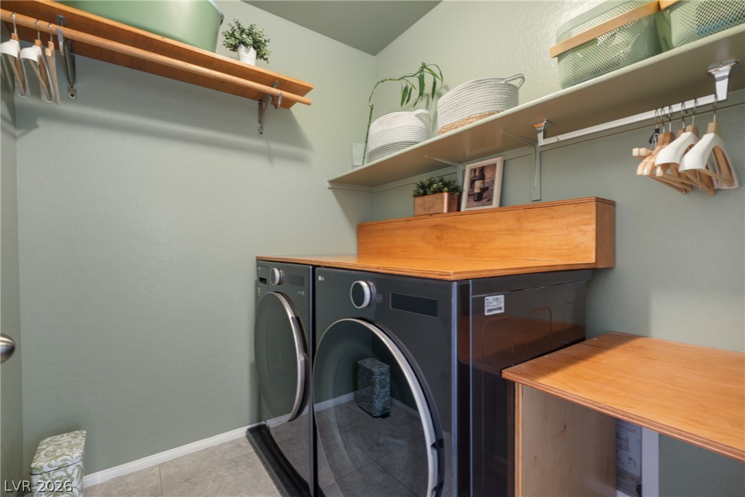 891 Earth Luster Road Las Vegas, NV 89178 - Photo 18 of 48 An organized laundry room offers convenience with practical shelving and efficient appliances.
