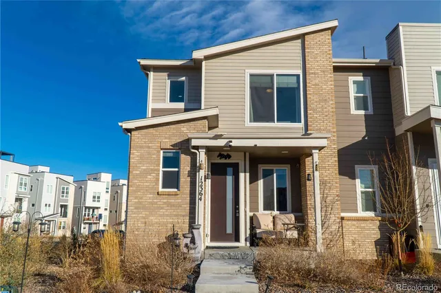 a front view of a house with large windows