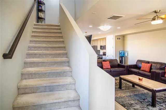 a living room with furniture and a stair