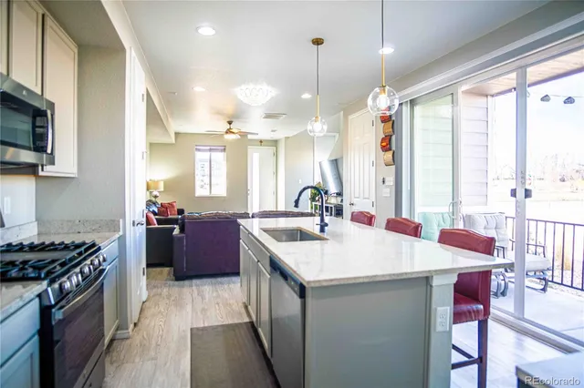 a kitchen with a stove a sink and a refrigerator
