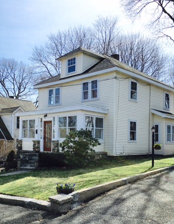 77 River Ridge Wellesley, MA 02481 - Photo 1 of 29 a front view of a house with garden