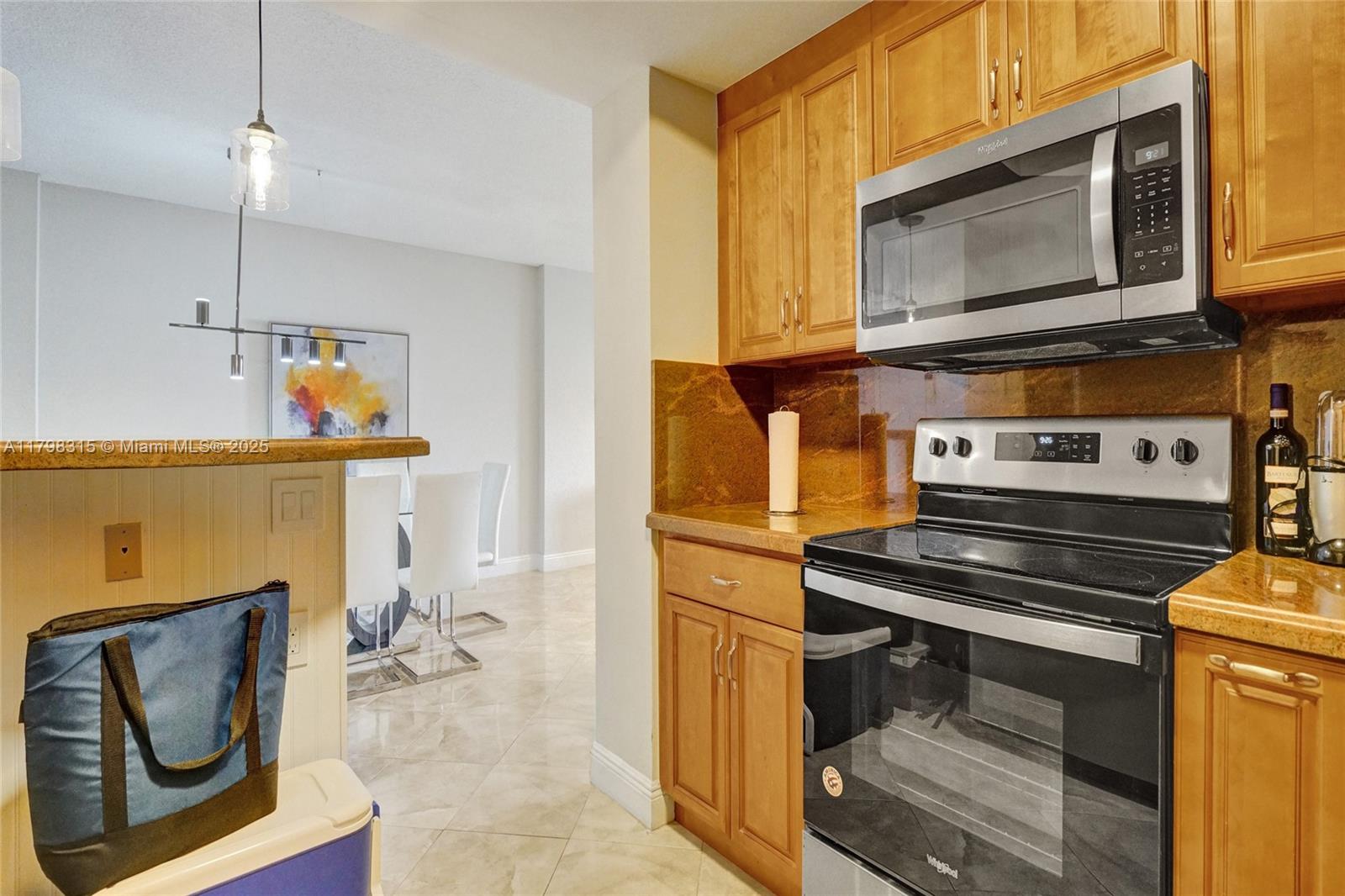 1980 South Ocean Drive, Unit 7J Hallandale Beach, FL 33009 - Photo 11 of 33 a kitchen with a stove and a microwave