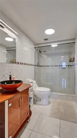 a bathroom with a sink a toilet and a shower