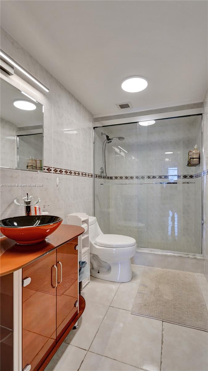 1980 South Ocean Drive, Unit 7J Hallandale Beach, FL 33009 - Photo 13 of 33 a bathroom with a sink a toilet and a shower