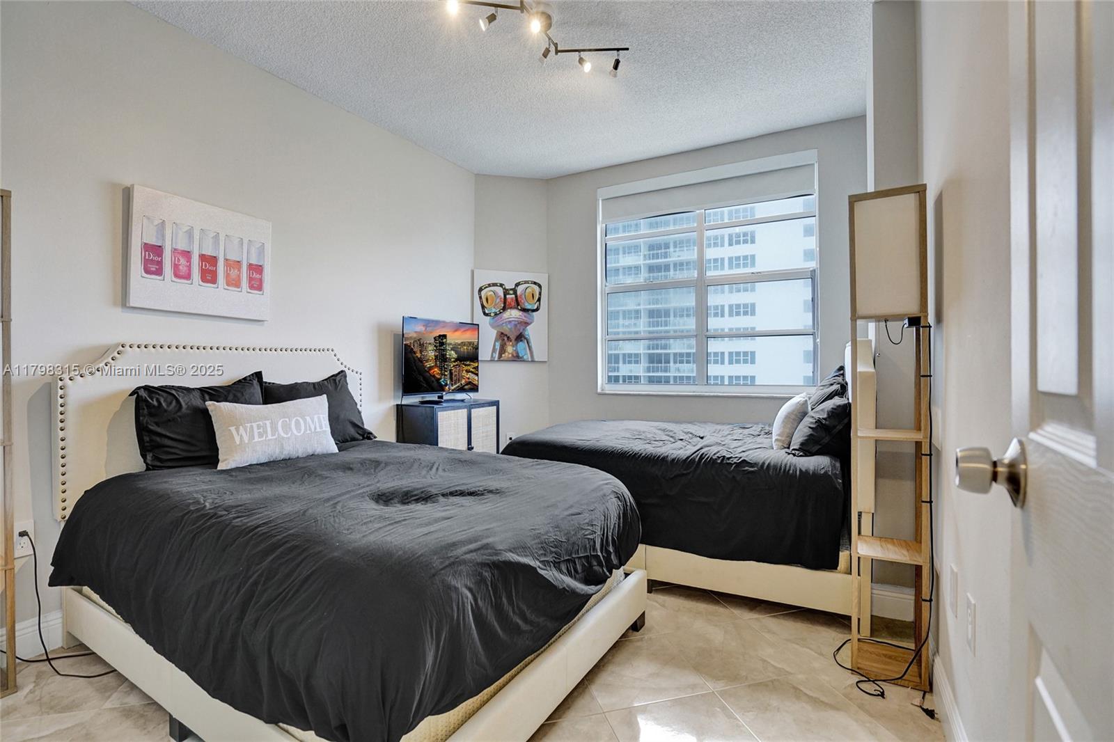 1980 South Ocean Drive, Unit 7J Hallandale Beach, FL 33009 - Photo 15 of 33 a bedroom with a bed and a window