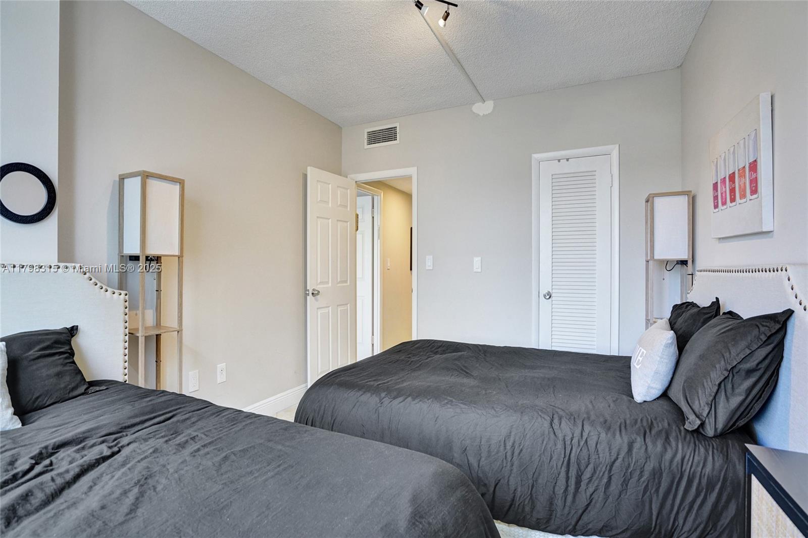 1980 South Ocean Drive, Unit 7J Hallandale Beach, FL 33009 - Photo 16 of 33 a bedroom with a bed and a closet