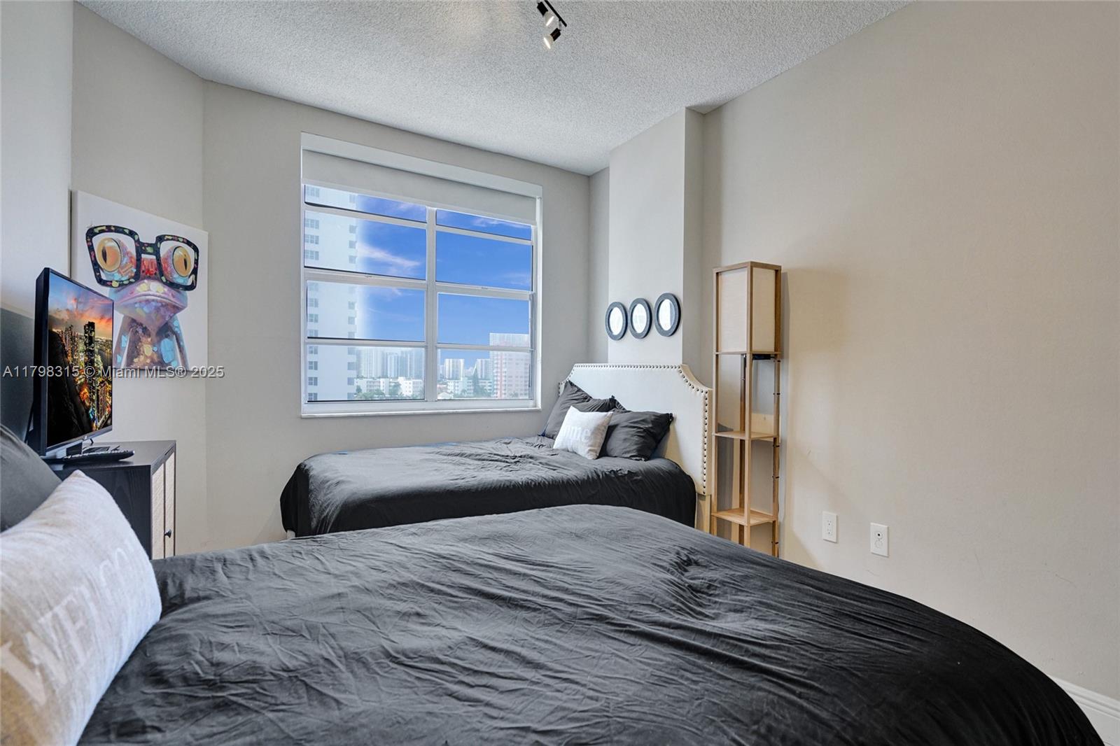 1980 South Ocean Drive, Unit 7J Hallandale Beach, FL 33009 - Photo 17 of 33 a bedroom with a bed and a window