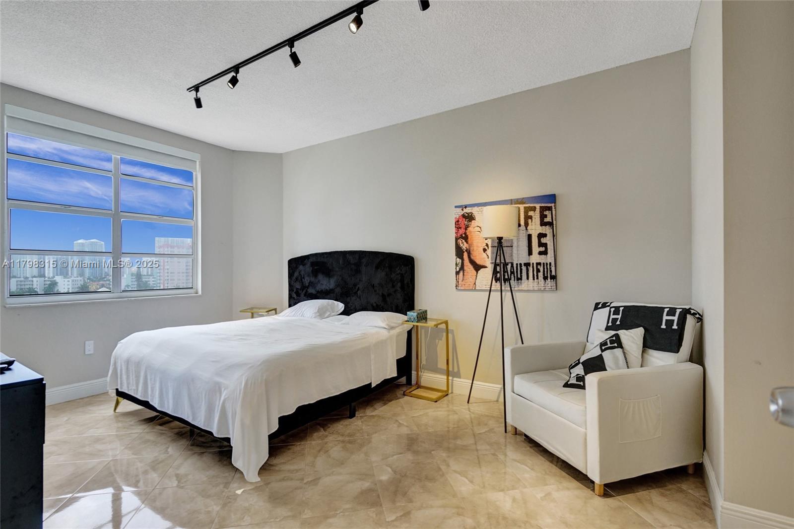 1980 South Ocean Drive, Unit 7J Hallandale Beach, FL 33009 - Photo 19 of 33 a bedroom with a bed and window