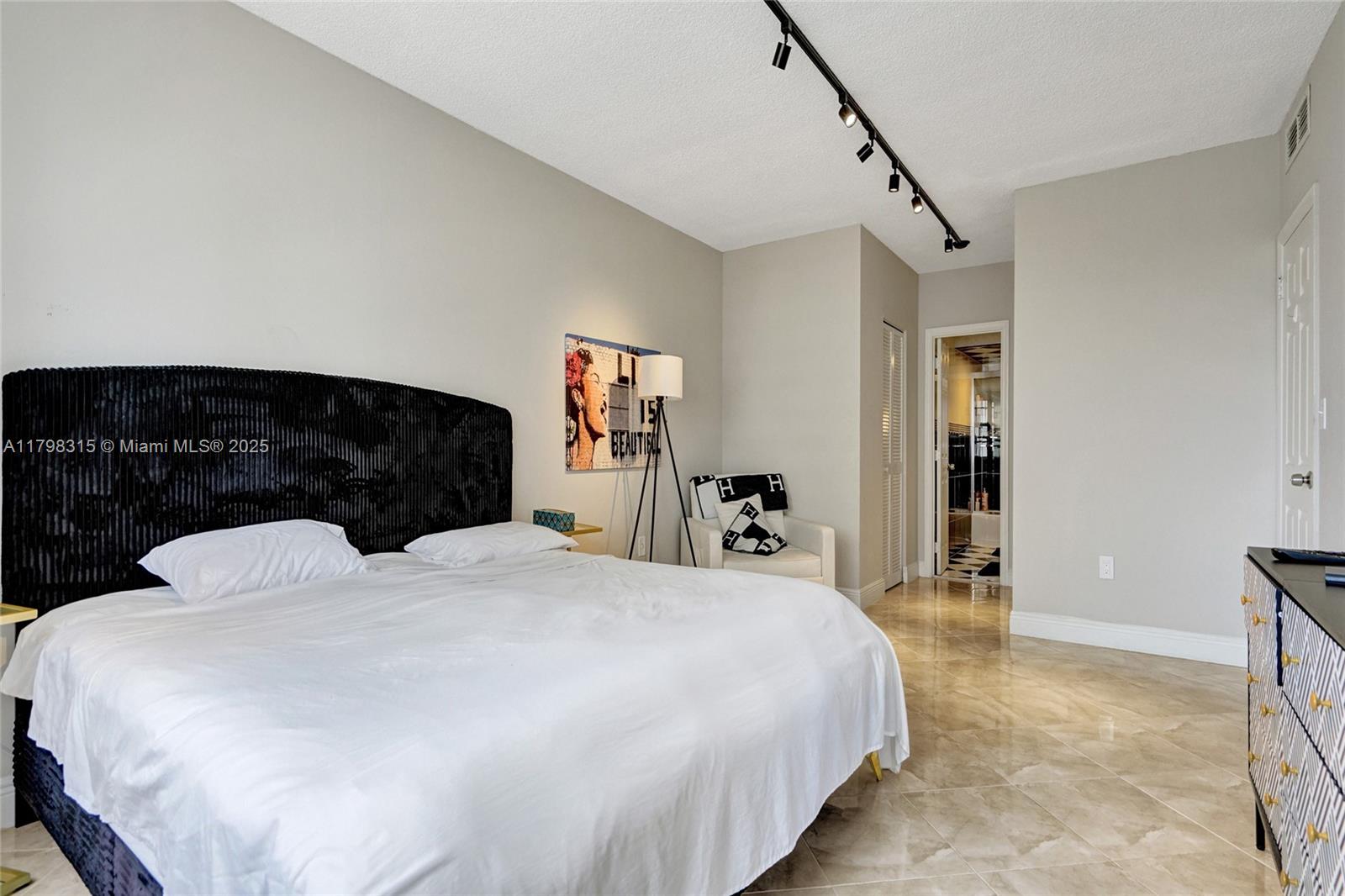 1980 South Ocean Drive, Unit 7J Hallandale Beach, FL 33009 - Photo 20 of 33 a bedroom with a bed and wooden floor