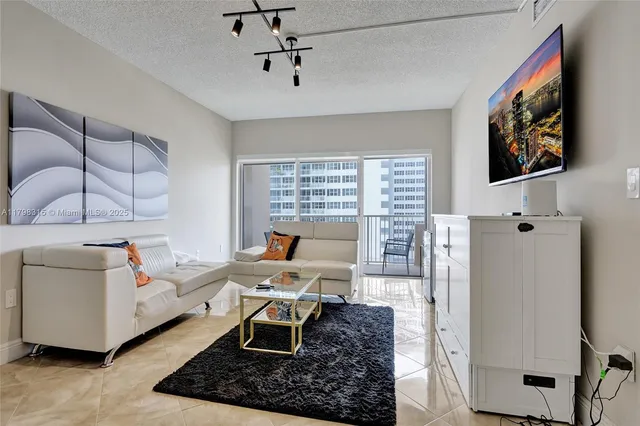 a work room with furniture and a flat screen tv