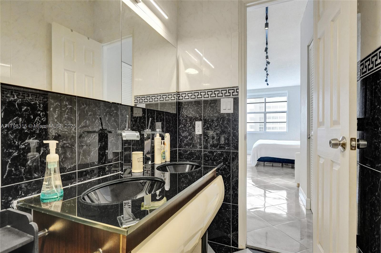 1980 South Ocean Drive, Unit 7J Hallandale Beach, FL 33009 - Photo 24 of 33 a kitchen with a sink and chandelier