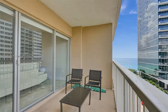 a view of a chair and table in a balcony