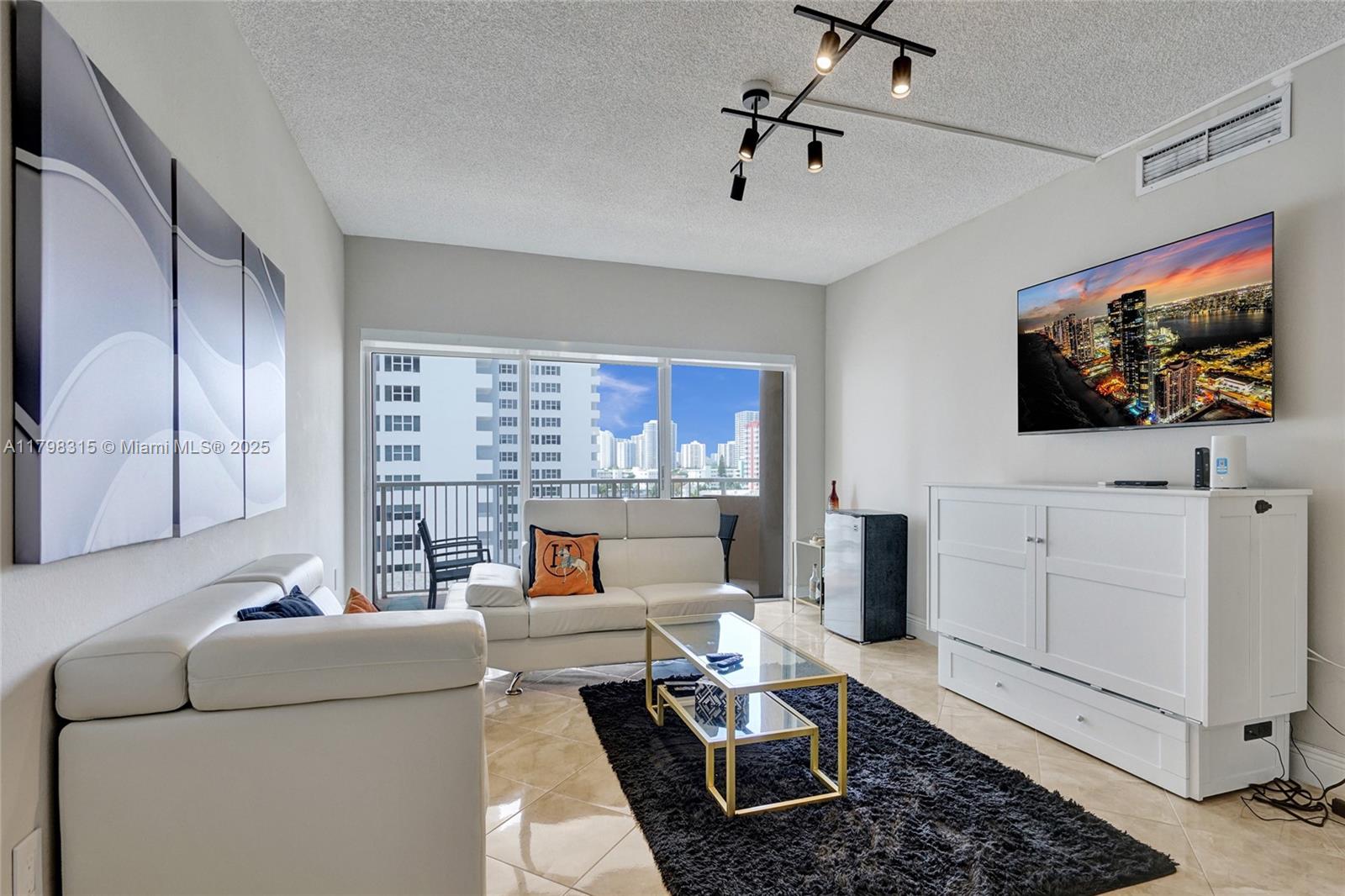 1980 South Ocean Drive, Unit 7J Hallandale Beach, FL 33009 - Photo 3 of 33 a living room with furniture and a flat screen tv