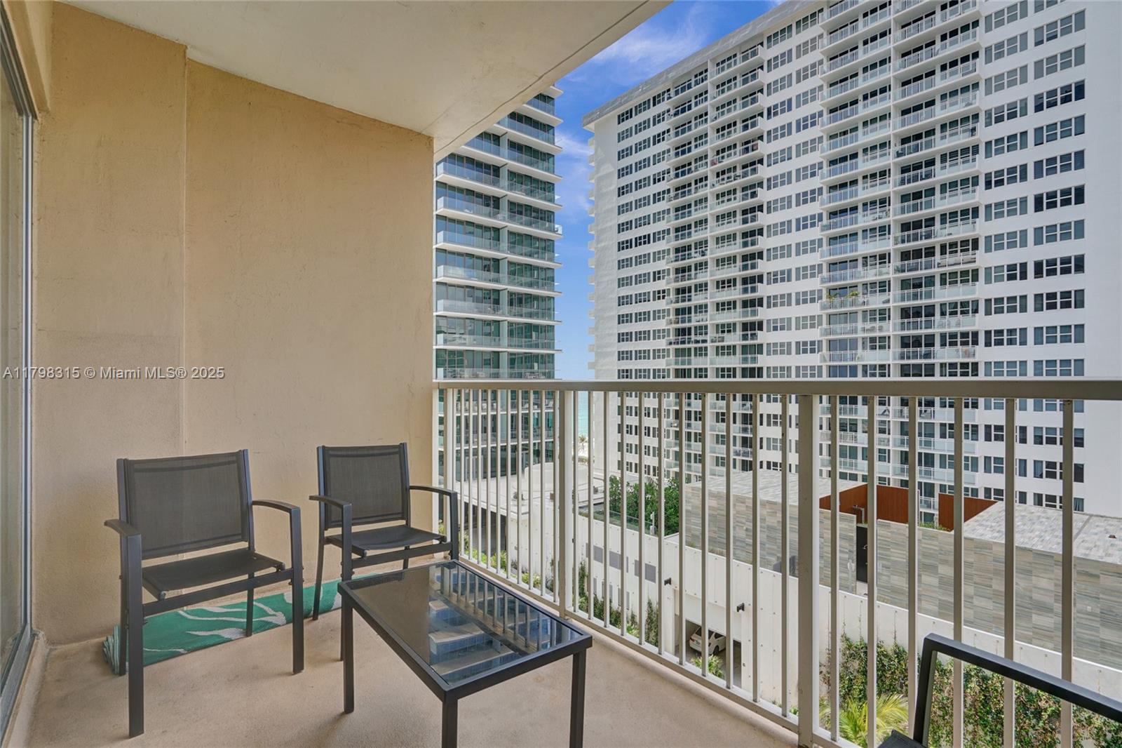 1980 South Ocean Drive, Unit 7J Hallandale Beach, FL 33009 - Photo 31 of 33 a view of a chair and table in a balcony