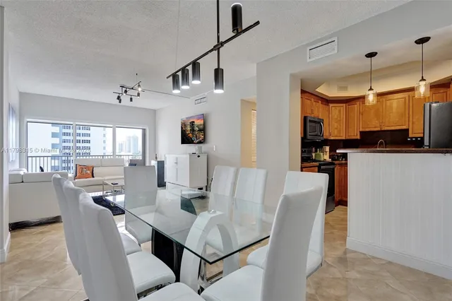a view of a dining room with furniture and a window