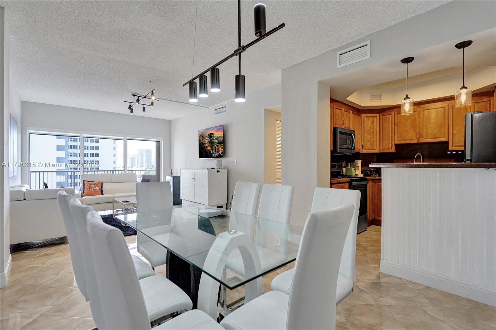 1980 South Ocean Drive, Unit 7J Hallandale Beach, FL 33009 - Photo 5 of 33 a view of a dining room with furniture and a window
