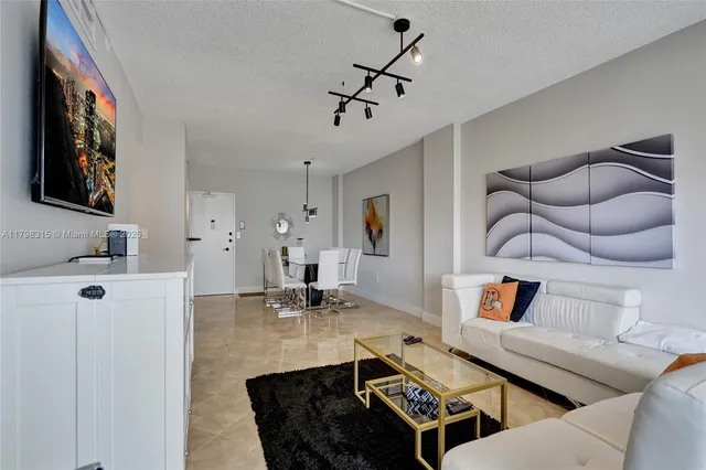 a living room with furniture and kitchen view