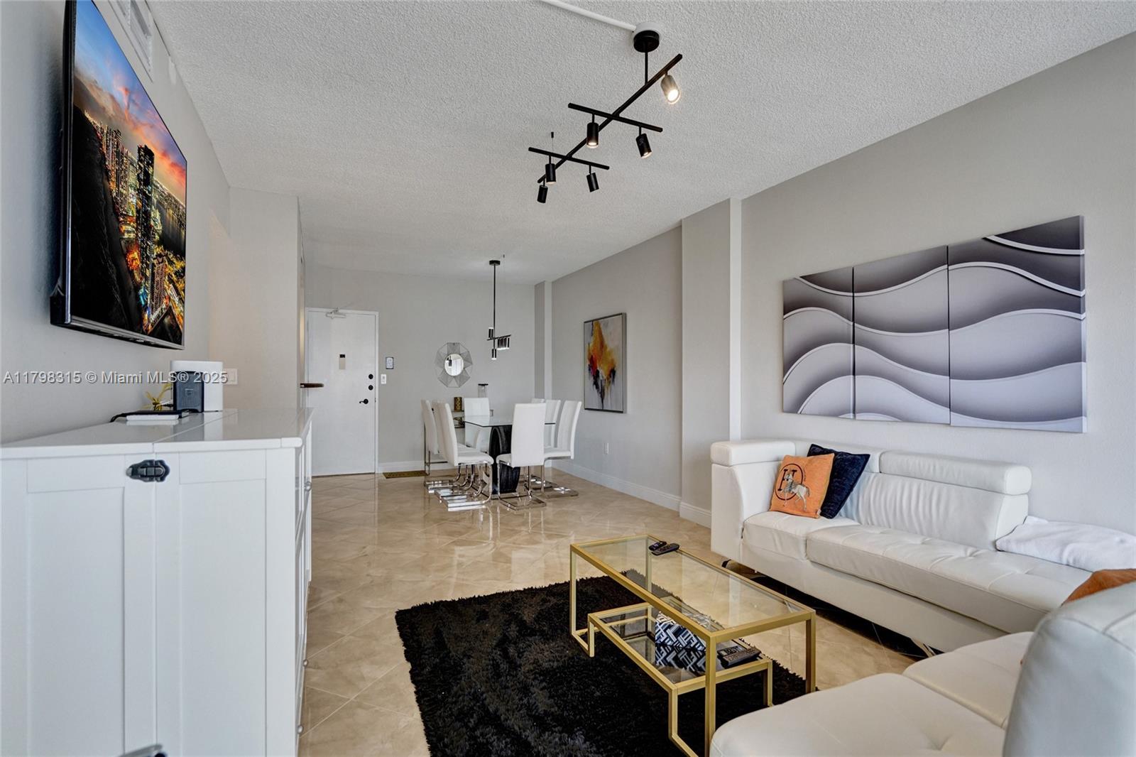 1980 South Ocean Drive, Unit 7J Hallandale Beach, FL 33009 - Photo 8 of 33 a living room with furniture and kitchen view