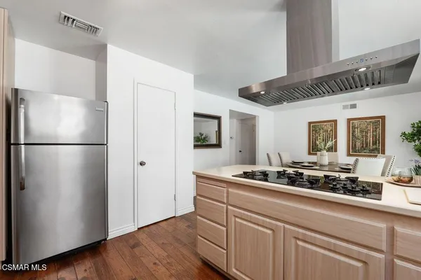 a kitchen with stainless steel appliances granite countertop a refrigerator and a sink