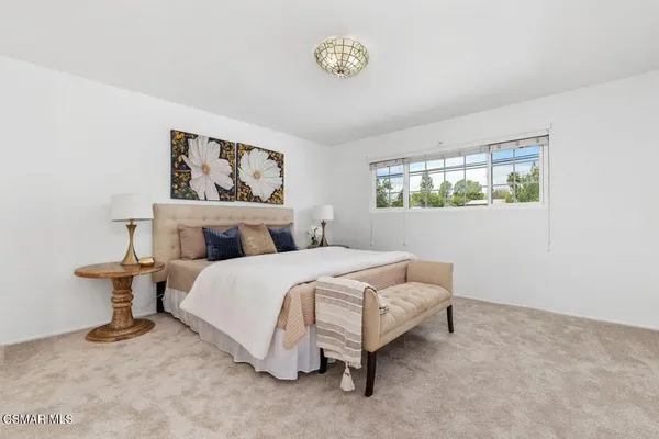 a bedroom with bed and window