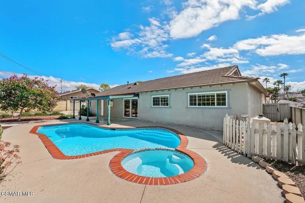 a view of a house with swimming pool and porch
