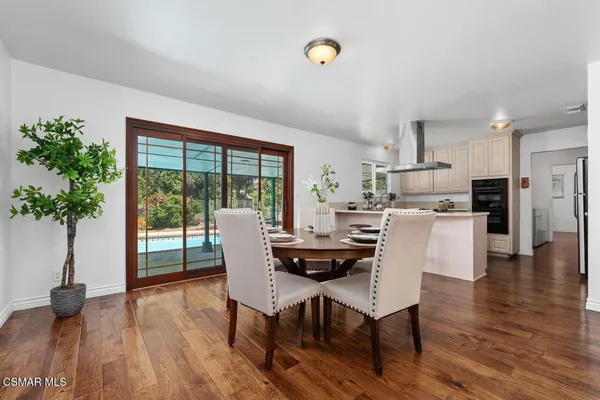 a dining room with furniture and wooden floor