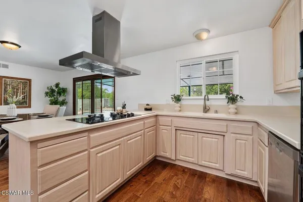 a kitchen with a sink cabinets and window