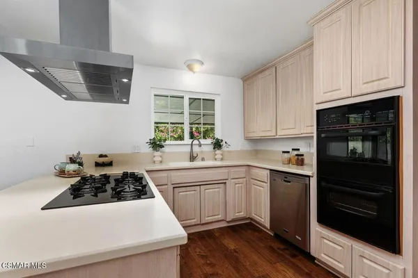 a kitchen with a sink stove and cabinets