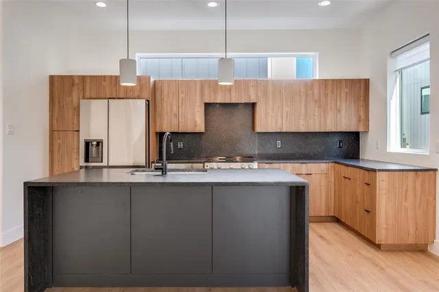 a kitchen with a sink a cabinets and window