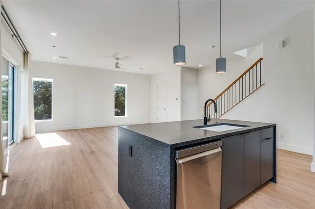 a living room with furniture and large windows