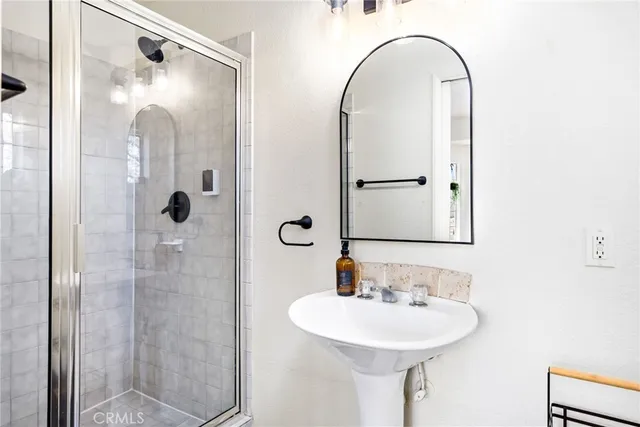 a bathroom with a sink and shower