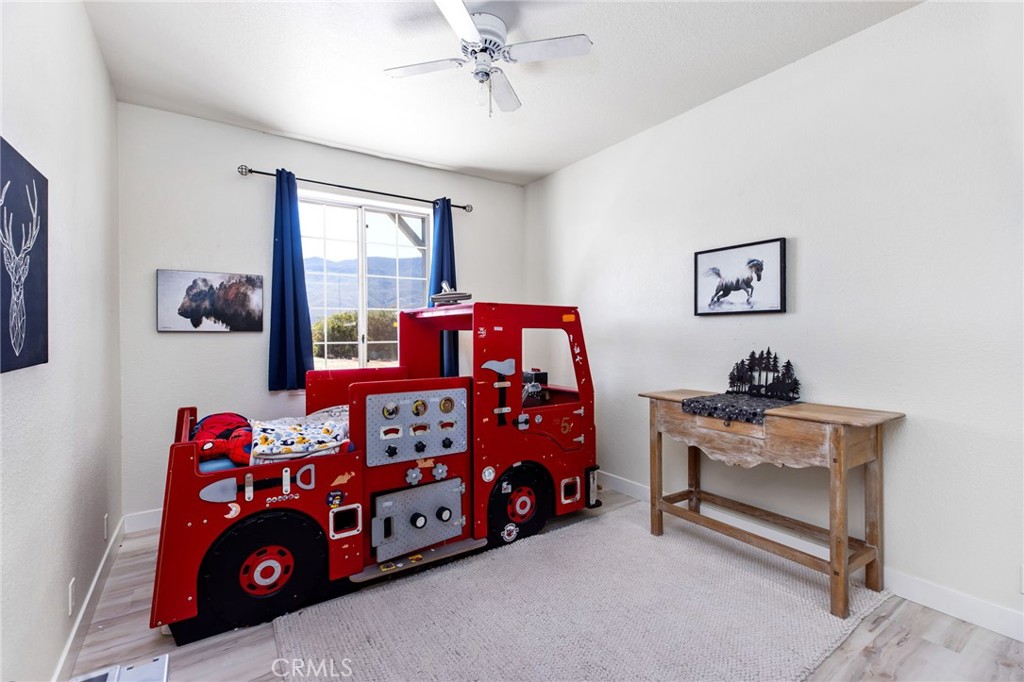 69945 Pinesmoke Road Mountain Center, CA 92561 - Photo 16 of 25 a bedroom with a bed and a chandelier