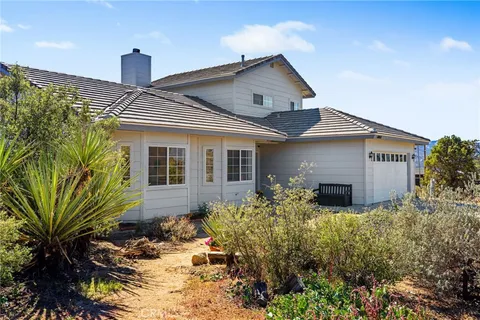 a front view of a house with yard and seating space