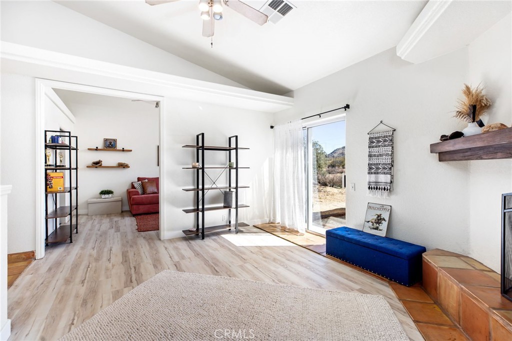 69945 Pinesmoke Road Mountain Center, CA 92561 - Photo 6 of 25 a spacious bedroom with a bed and wooden floor
