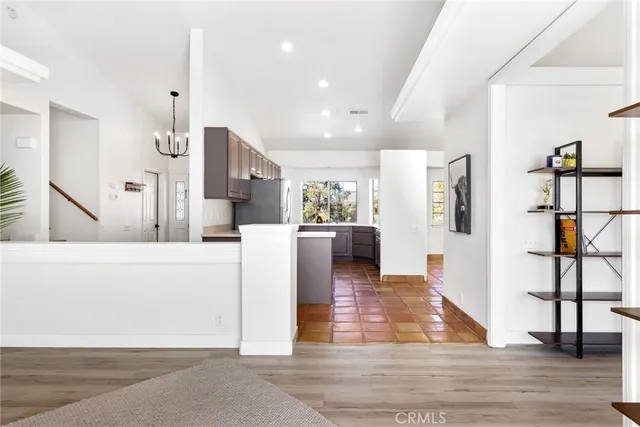 a living room with furniture and kitchen view