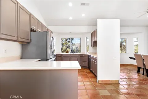 a large white kitchen with a large window