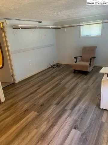 a view of a room with wooden floor