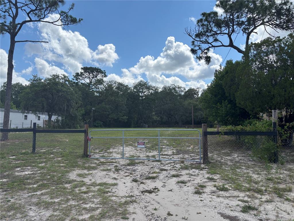 15546 Hicks Road Hudson, FL 34667 - Photo 1 of 8 a backyard of a house with lots of green space