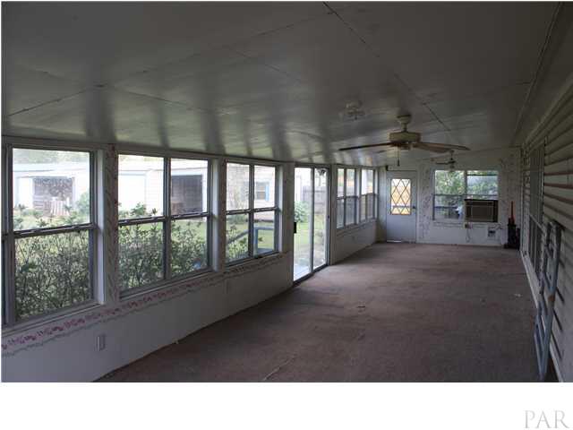 9848 American Farms Road Milton, FL 32583 - Photo 4 of 21 Enlosed Sunporch w/Window AC Unit