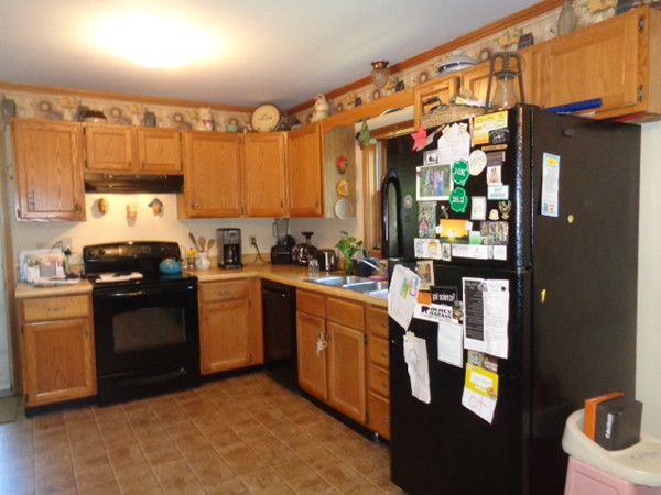 220 Dana Road Orange, MA 01364 - Photo 3 of 9 a kitchen with stainless steel appliances granite countertop a refrigerator a sink a stove top oven a counter space and cabinets