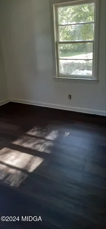 a view of a livingroom with an empty space and a window