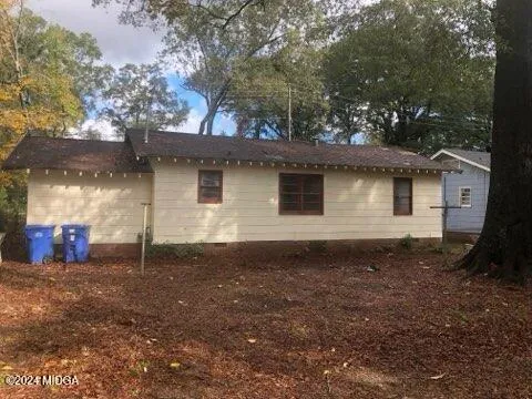 a view of a backyard with large trees