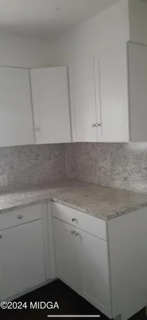 a kitchen with a sink and cabinets